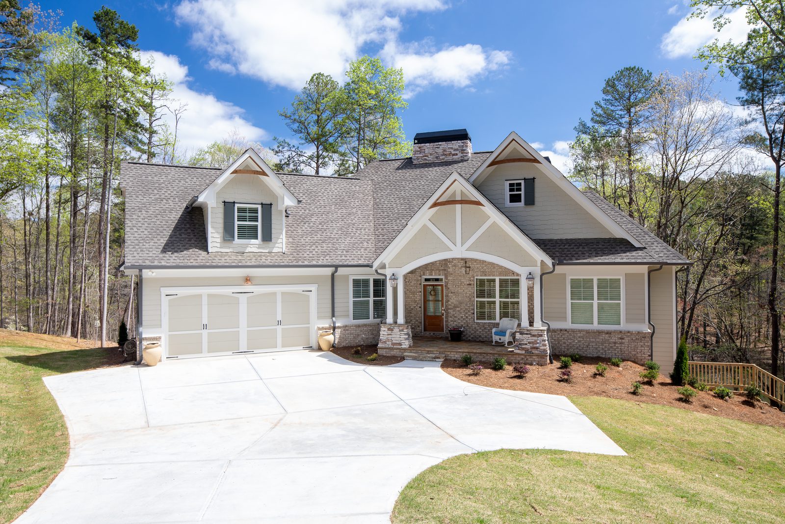 Craftsman front elevation with three-car garage and stone accents — Spring 2020 Custom Home, custom home built by Ironwood Construction Group